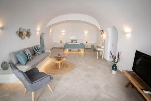 a living room with a couch and a table at Sun Angelos Oia - Luxury Cave Suites in Oia