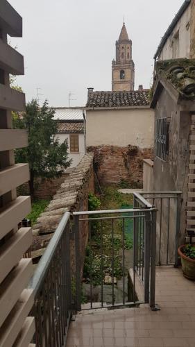 an old building with a clock tower and stairs at nel centro storico casa vacanze I Mughetti in Citta' Sant'Angelo