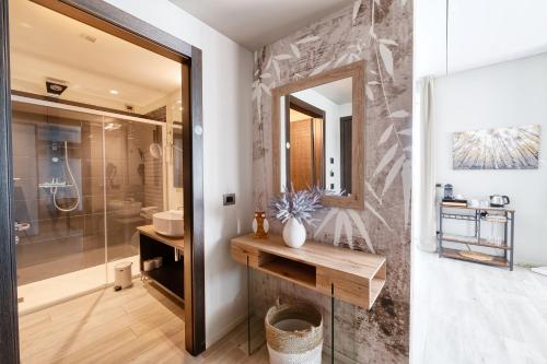 a bathroom with a shower and a sink and a mirror at Vision Hotel in Peschiera del Garda