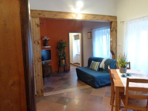 a living room with a blue couch and a table at Soča House Tolmin in Tolmin