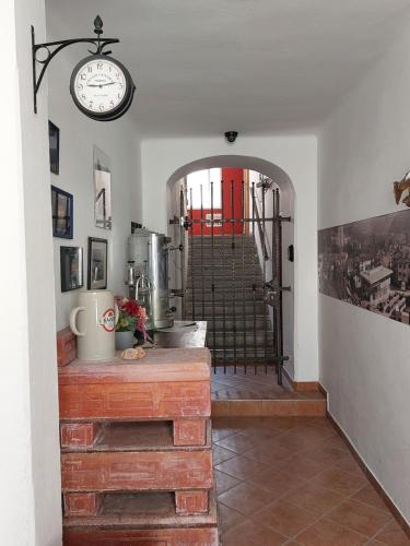 a room with a clock on the wall and a staircase at The Soča House Tolmin in Tolmin