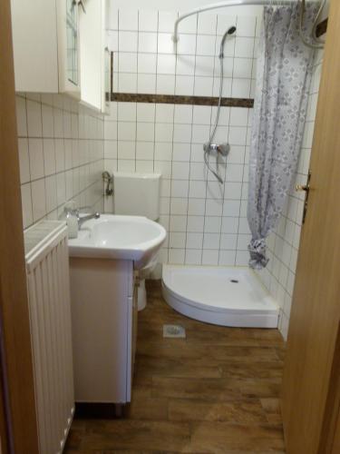 a bathroom with a sink, toilet and bathtub at Apartment Soca Tolmin in Tolmin