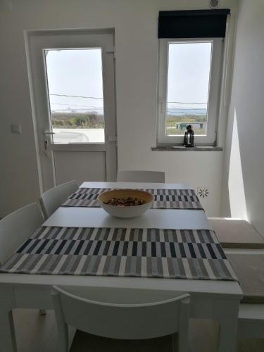 a table with a bowl on it with two windows at Baleal Atlantic View House in Baleal