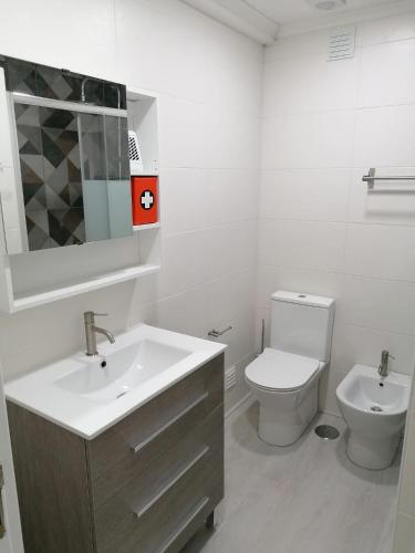 a white bathroom with a sink and a toilet at Baleal Atlantic View House in Baleal