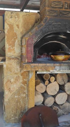 a stone oven with a bowl on top of it at Villa Anthemida Chania in Ayiá