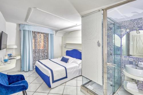 a bedroom with a bed and a shower and a sink at Le Botteghe 59 Capri in Capri