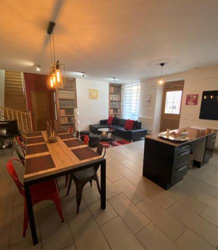 a living room with a table and a couch at La Halte Effervescente in Épernay