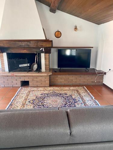 a living room with a couch and a fireplace at CasaLonghi in Mantova