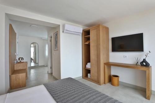 a bedroom with a bed and a television on a wall at Lavinya Otel in Golturkbuku
