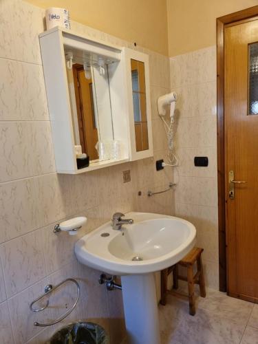 a bathroom with a white sink and a mirror at Hotel Plammas in Santa Maria Navarrese