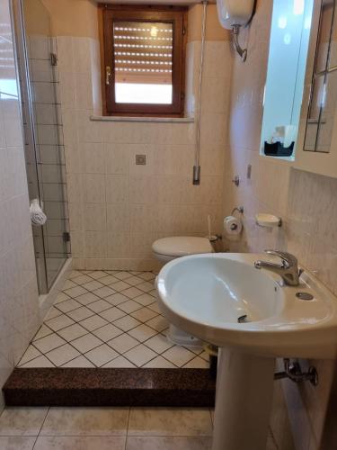a bathroom with a sink and a toilet at Hotel Plammas in Santa Maria Navarrese