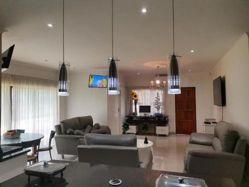 a living room with two couches and a table at QTEN CASINO in Pietermaritzburg
