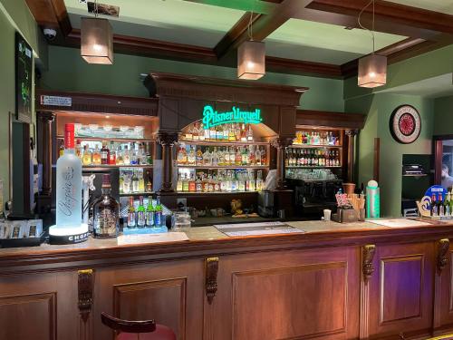 a bar in a pub with a lot of alcohol at Złote Arkady in Częstochowa