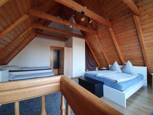 two beds in a room with wooden ceilings at Wohnung Westerholt in Westerholt