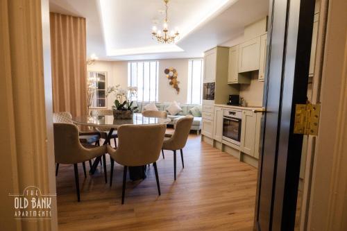 a kitchen and dining room with a table and chairs at The Old Bank Apartments in Blackpool
