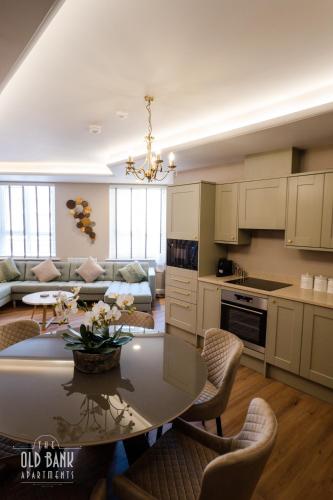 a kitchen and living room with a table and chairs at The Old Bank Apartments in Blackpool