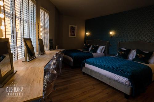 a hotel room with two beds and a television at The Old Bank Apartments in Blackpool
