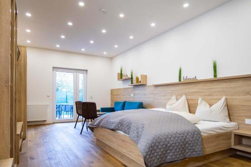 a bedroom with a bed and a desk and chairs at Luxury Apartment Monte Carlo in Pörtschach am Wörthersee