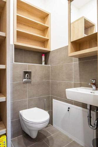a bathroom with a toilet and a sink at Luxury Apartment Monte Carlo in Pörtschach am Wörthersee