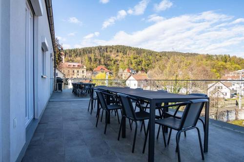 a large black table and chairs on a balcony at Luxury Apartment Monte Carlo in Pörtschach am Wörthersee