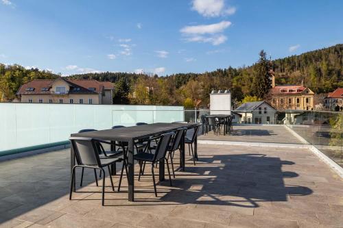 a group of tables and chairs on a patio at Luxury Apartment Monte Carlo in Pörtschach am Wörthersee