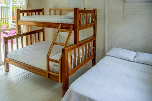 two bunk beds in a room next to a bed at Quinta del Mar La Joya in Tolú