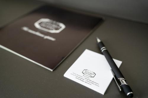 a pen sitting on a table next to a notebook at Hotel Astoria in Bologna
