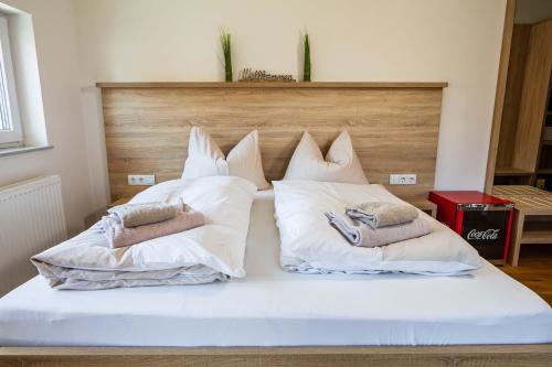 a white bed with two pillows on top of it at Luxury Apartment Monte Carlo in Pörtschach am Wörthersee