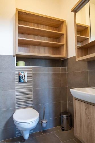 a bathroom with a toilet and a sink at Luxury Apartment Monte Carlo in Pörtschach am Wörthersee