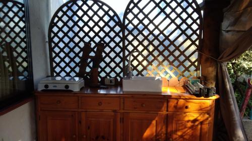 a wooden dresser with two lights on top of it at Tiny House in Cagliari