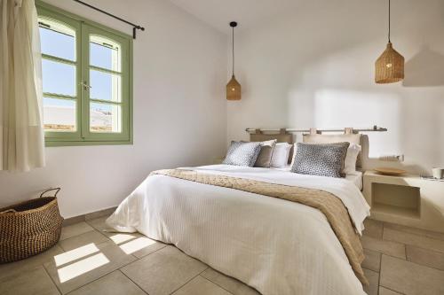 Postel nebo postele na pokoji v ubytování Antamoma Suites