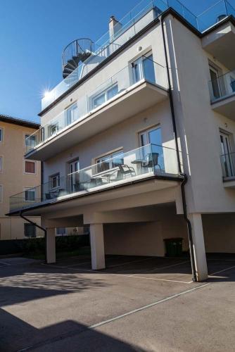 a large white building with a balcony on it at Luxury Apartment Monte Carlo in Pörtschach am Wörthersee