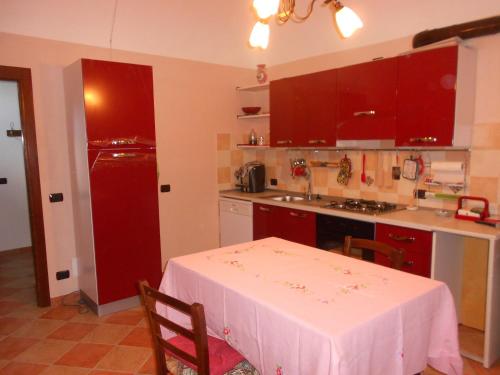 a kitchen with a table and a red refrigerator at Agriturismo Monrabbioso in Cereseto