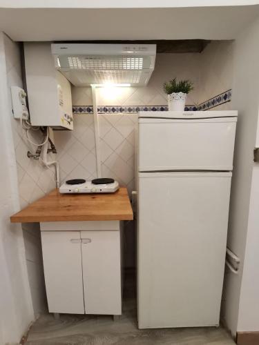 a small kitchen with a white refrigerator and a counter at Party Zone in Lisbon