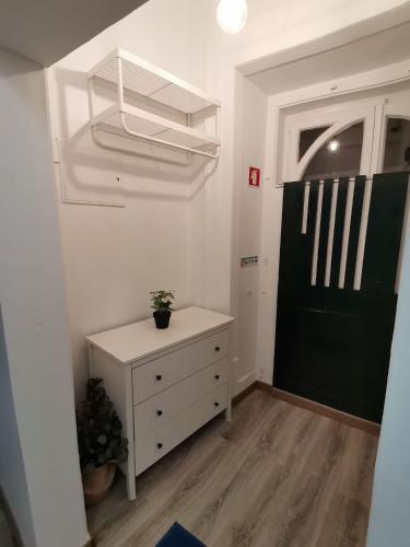 a room with a white dresser and a black door at Party Zone in Lisbon