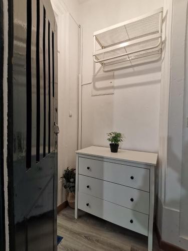 a white dresser with a plant on it in a room at Party Zone in Lisbon
