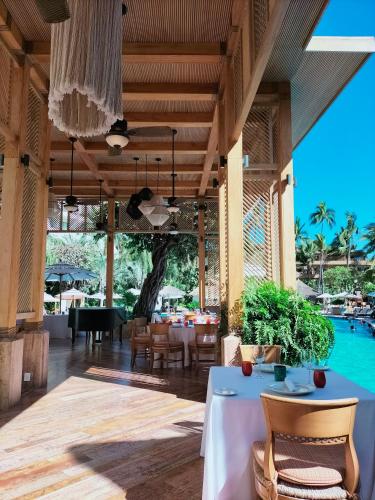 a dining room with a table and a pool at Fiesta Americana Puerto Vallarta All Inclusive & Spa in Puerto Vallarta