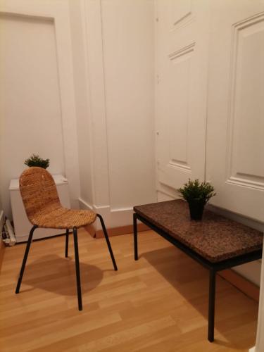 a chair and a table in a room at Party Zone in Lisbon