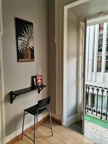 a black chair in a room with a window at Party Zone in Lisbon