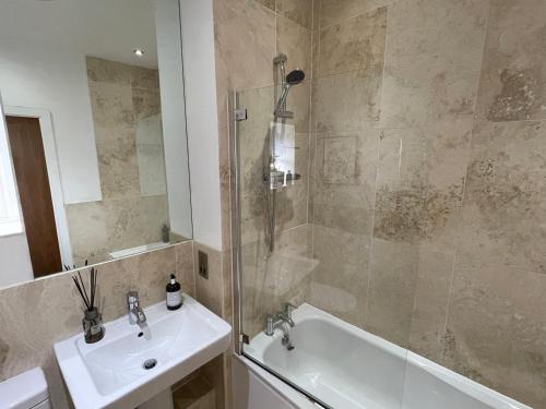 a bathroom with a shower and a sink and a tub at Award Winning Apartment in Yarm, North Yorkshire in Yarm