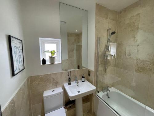 a bathroom with a sink and a toilet and a tub at Award Winning Apartment in Yarm, North Yorkshire in Yarm
