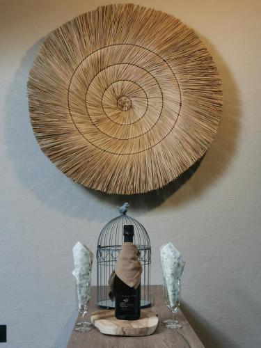 a wooden table with a bird cage and two wine glasses at La Canopée in Cholet