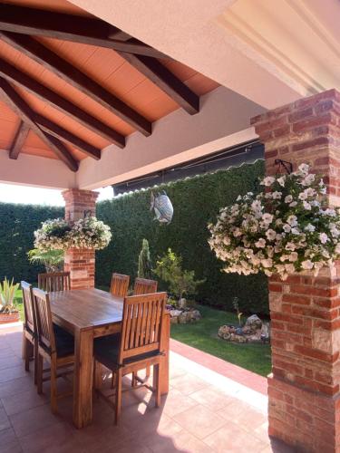 a wooden table and chairs on a patio at Villa Eva Karigador in Novigrad Istria