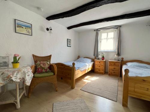 a bedroom with two beds and a table and chairs at Villa Velo in Eschwege