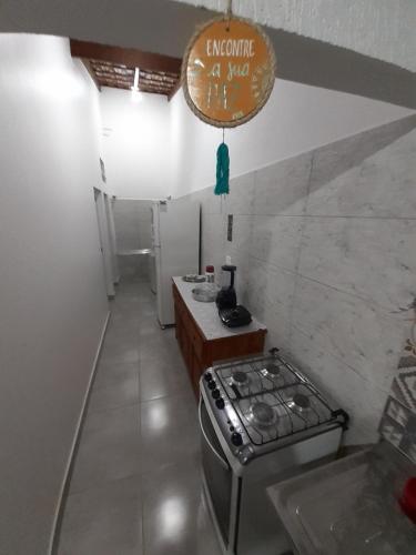 a small kitchen with a stove and a counter at A VER O MAR FLATS in Caraguatatuba