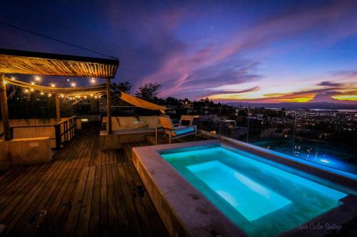 a swimming pool on a deck with a view of a city at Cuna del Cielo in San Miguel de Allende