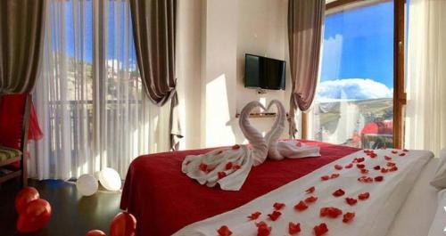 a bedroom with a bed with red roses on it at Hotel Scardus in Tetovo