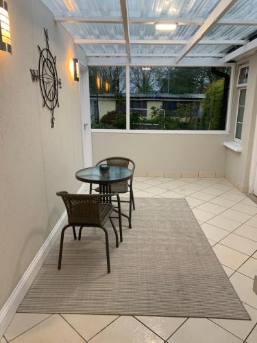 a patio with a table and chairs on a rug at Stonehaven in Kilkenny