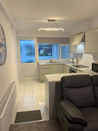 a kitchen and living room with a couch and a table at Stonehaven in Kilkenny