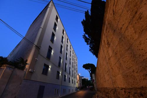 a tall white building on the side of a street at Hotel Auditorium in Bari
